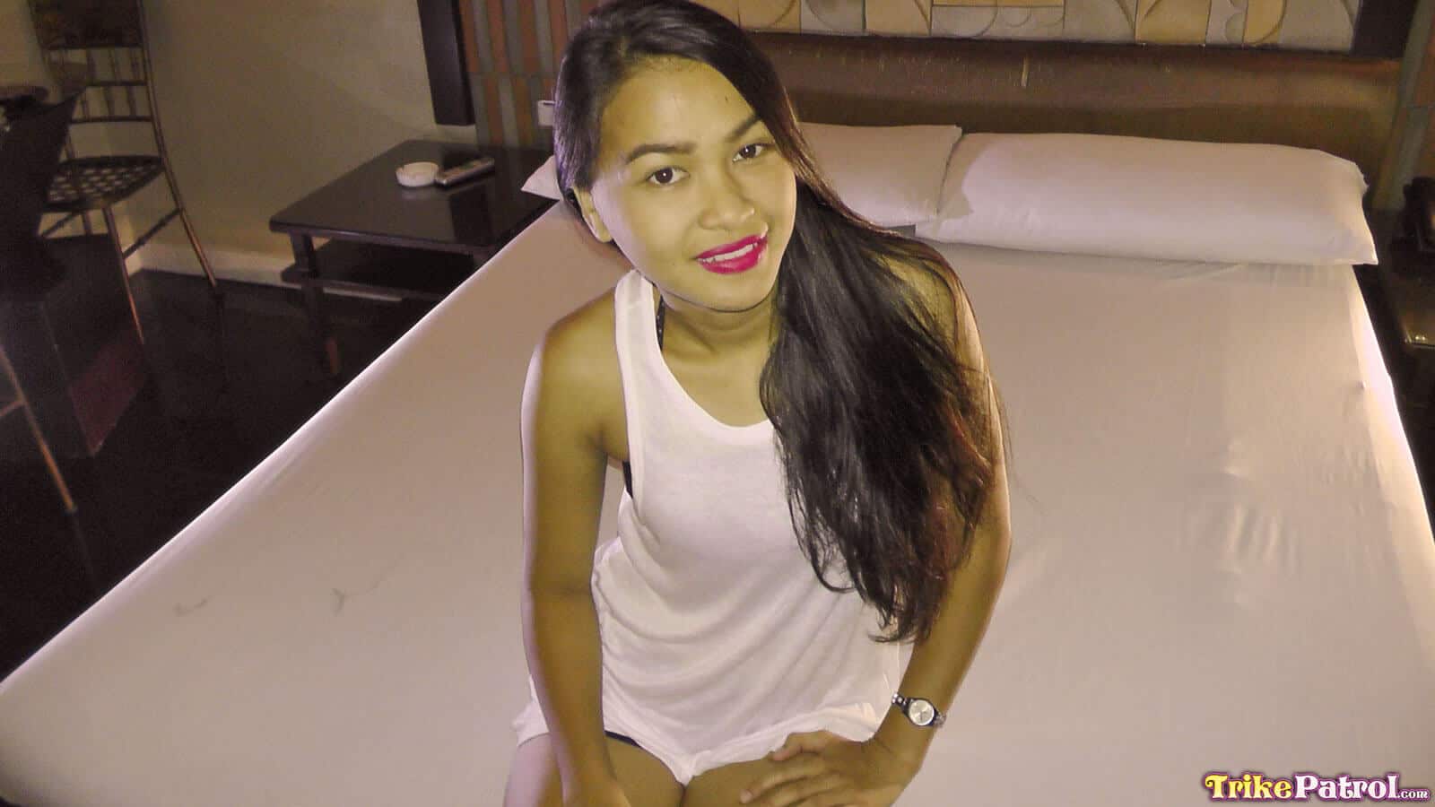 Friendly Asian girl models in bed