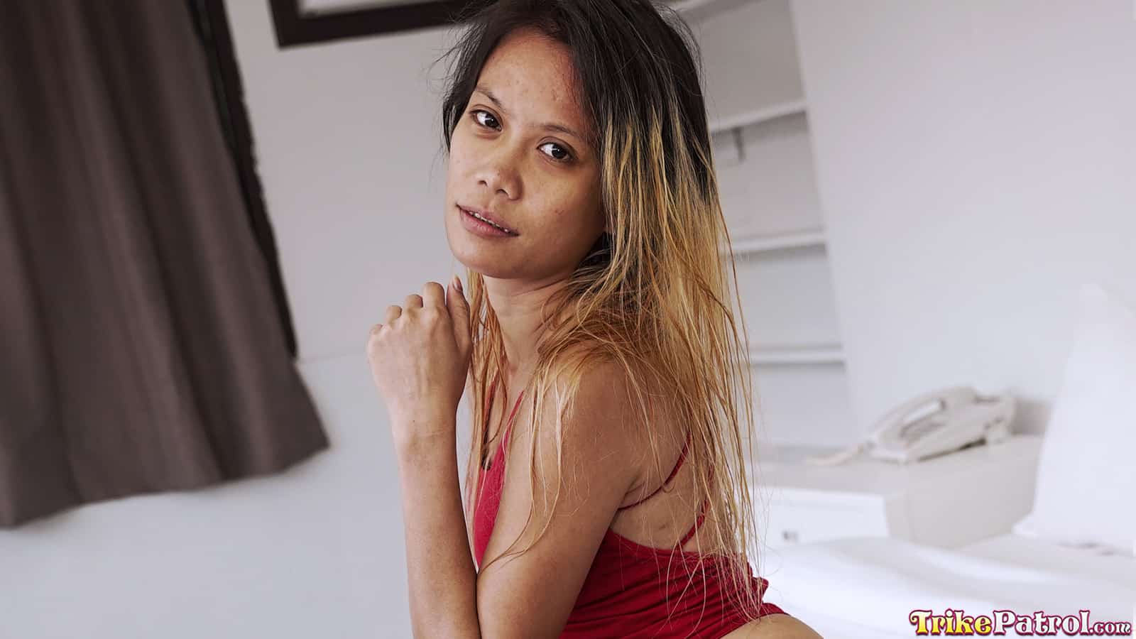 Hot Asian milf poses for the camera at trikepatrol