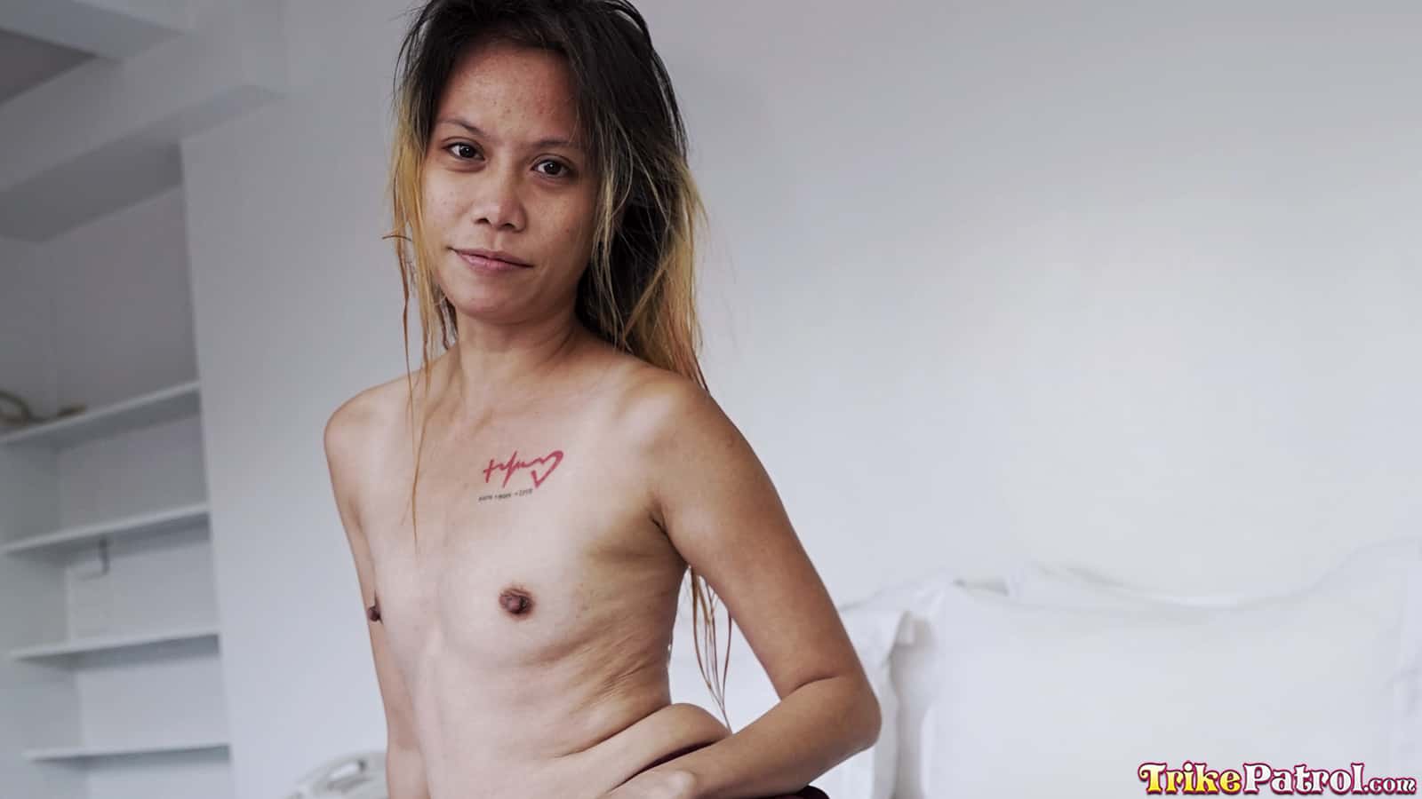 Slender Asian milf disrobes and shows her small boobs